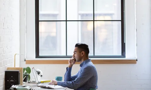Student researching at his desk 